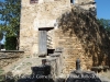 Església parroquial de Sant Esteve – Cornellà del Terri - Per la porta mig oberta es veuen uns quants nínxols del cementiri