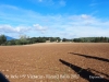 Vistes desde l'Església parroquial de Sant Iscle i Santa Victòria – Esponellà. Al fons, al bell mig de la fotografia es pot veure molt petitona, l'espadanya de la capella de Sant Miquel de Centenys